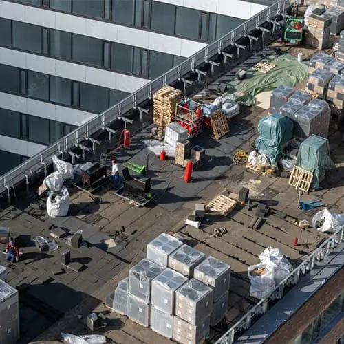 Aerial view of a commercial flat roof replacement in Toronto&mdash;Right Choice Roofing and Repair crew on a high-rise roof with materials staged.