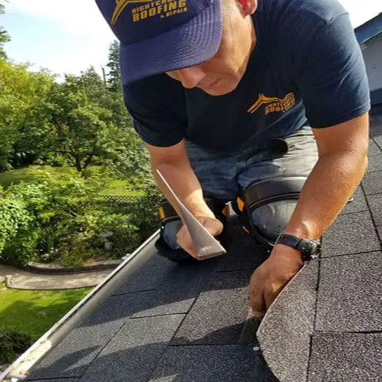 Experienced Toronto roofer in Right Choice Roofing and Repair gear kneels on a two-storey sloped roof finishing an asphalt shingle repair&mdash;trusted for roof repair, roof replacement, and slate roofing.