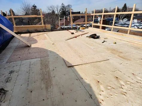 Flat roof replacement in progress on a Toronto building fix ongoing flat roof leakage.