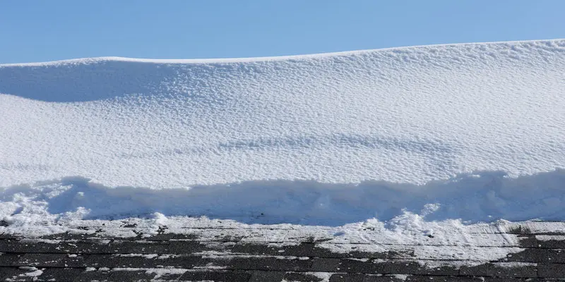 Ice damming along a Toronto roof edge showing how snow and ice buildup can cause roof leaks, roof repair issues, roof replacement needs, and slate roofing damage in winter.