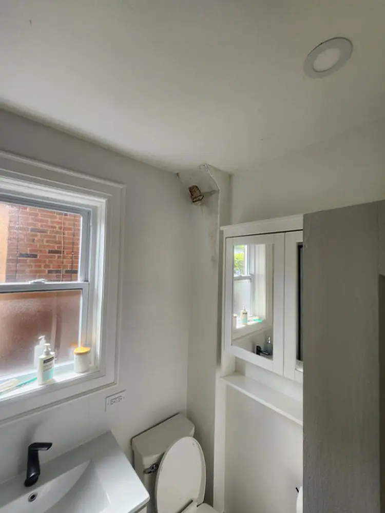 Interior water damage near a ceiling corner in a Toronto home showing early signs of a roof leak that may require roof repair, roof replacement, or slate roofing repairs.