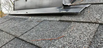 Poorly installed roof flashing at a wall junction in Toronto, showing installation issues that can cause roof leaks and require professional roof repair.