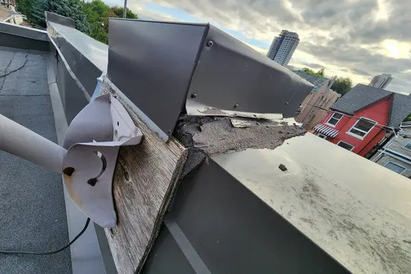 Roof flashing and penetration damage on a Toronto building showing a common exterior source of roof leaks that may require roof repair or roof replacement.