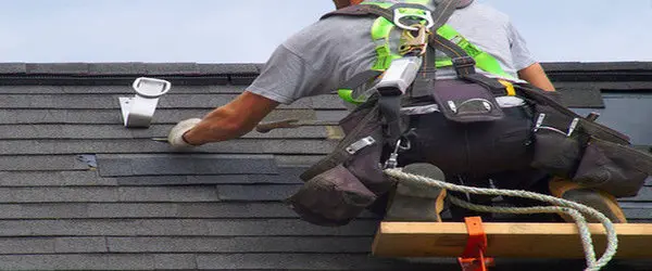 Roofer performing roof shingles repair on a Toronto home, showing professional roof repair work to prevent leaks and winter weather damage.