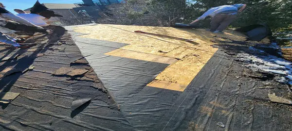 Roof shingles replacement on a Toronto home showing old materials removed to fix an active roof leak and prepare for new roofing installation.