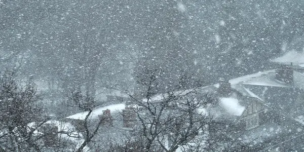 Heavy snowfall on Toronto residential roofs during winter storm increasing risk of structural damage and ice dams