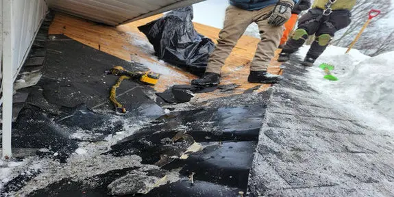 Winter storm damage to Toronto roof showing missing shingles requiring emergency repair