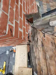 Brick Chimney prep complete after decades of patchwork Flashing layers removed and board substrate cleaned up on a Rosedale Toronto heritage Slate Roof by Right Choice Roofing and Repair
