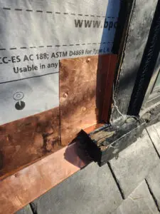 Detailed copper flashing installation with copper nails on a Toronto slate roof dormer by Right Choice Roofing and Repair.