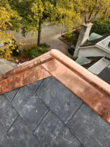 Finished sistered copper Ridge Cap closure at the three-face corner of a main sloped Roof with new natural Slate on a Rosedale Toronto heritage home by Right Choice Roofing and Repair