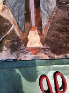 Progress photo showing custom fabricated copper ridge cap tie-in flashing closure at junction between main sloped roof and copper flat roof during slate roof replacement in Harbord Village Toronto by Right Choice Roofing and Repair