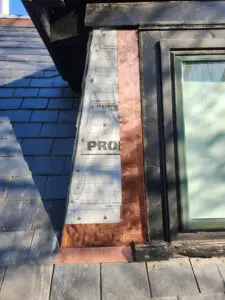 Right Choice Roofing and Repair installing custom copper sidewall flashing on a Toronto slate dormer project.
