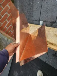 Hand-fabricated custom copper Chimney Back Pan Flashing (Cricket) designed to shed water away from the back of a brick Chimney on a Rosedale Toronto heritage Slate Roof by Right Choice Roofing and Repair