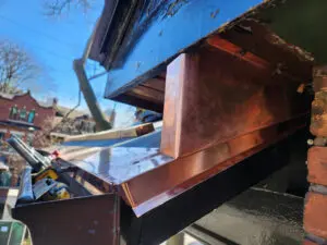Custom fabricated copper wildlife barrier enclosure for a soffit bulkhead in Toronto by Right Choice Roofing and Repair.