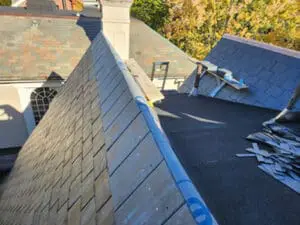 Two completed Dormer sloped Roofs with natural Slate courses and ice and water shield wrapped over the Hips on a Rosedale Toronto heritage home, ready for copper Hip and Ridge Caps