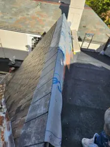 Completed Dormer sloped Roof with natural Slate courses and ice and water shield wrapped over the Hip on a Rosedale Toronto heritage home, ready for copper Hip and Ridge Cap installation