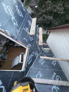 Progress photo showing full main roof slope covered in Grace Select underlayment with 2x4 step ups and wood plank work platforms on metal jacks staged during slate roof replacement in Harbord Village Toronto by Right Choice Roofing and Repair