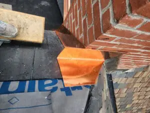 Custom hand-fabricated copper Chimney Back Pan Flashing installed at the corner of a brick Chimney on a Rosedale Toronto heritage Slate Roof with CertainTeed DiamondDeck underlayment and Grace ice and water shield in place by Right Choice Roofing and Repair