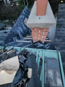 Progress photo showing Grace Select underlayment fully installed on main slope and dormer with demolition debris staged on flat roof below during slate roof replacement in Harbord Village Toronto by Right Choice Roofing and Repair