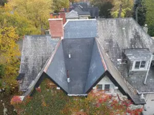 Completed natural Slate Roof and flat Roof replacement on a heritage home in Rosedale, Toronto, with new copper Valley Flashing
