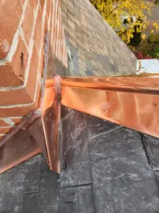 Final finish complete copper Chimney Flashing kit with Counter Flashing, peaked back pan, sistered Ridge Cap, and new natural Slate Roof on a Rosedale Toronto heritage home by Right Choice Roofing and Repair