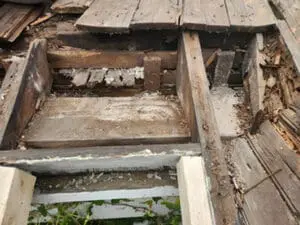 Flat Roof leak damage to the Roof structure exposed in Rosedale Toronto with rotted framing, debris, and new replacement lumber going in