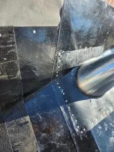 Close-up of a precisely fabricated aluminum high dome plumbing exhaust flange on a Rosedale Toronto flat Roof showing exact contour match around the pipe and deck