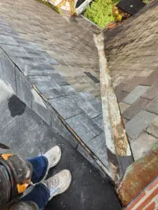 Top of a new copper Valley junction on a Rosedale Toronto heritage Slate Roof with the last course of natural Slate tiles tied in perfectly on both sides by Right Choice Roofing and Repair