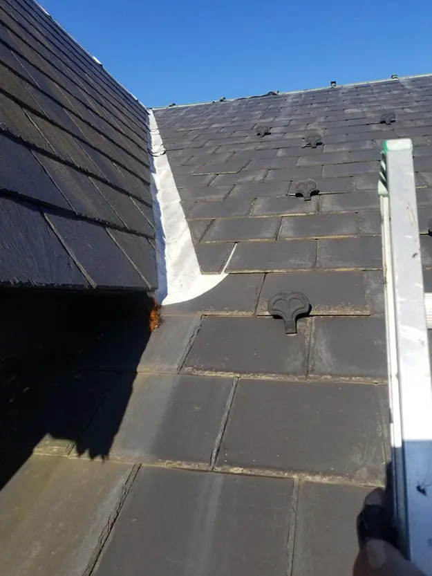 Before photo showing deteriorated lead roof flashing lifting away from slate tiles in Harbord Village Toronto prior to copper conversion by Right Choice Roofing and Repair