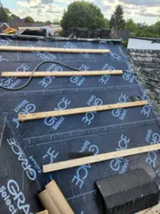 Progress photo looking up steep main slope showing Grace Select underlayment fully installed with 2x4 step ups spaced across pitch and copper roll staged at base during slate roof replacement in Harbord Village Toronto by Right Choice Roofing and Repair
