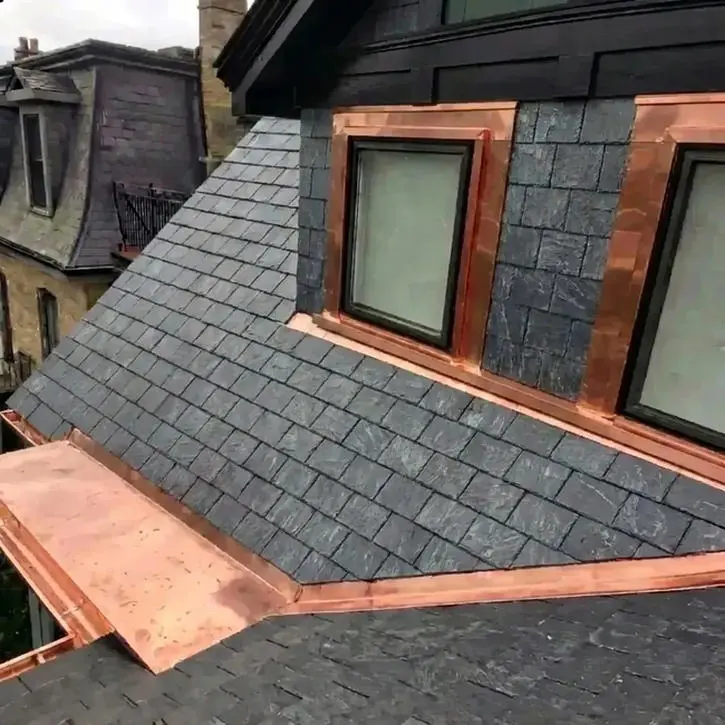 Completed slate roof replacement in Toronto showing natural slate tiles, custom copper valley, copper flat roof, eavestrough and copper window frame, sill and lintel coverings on a heritage dormer by Right Choice Roofing and Repair.