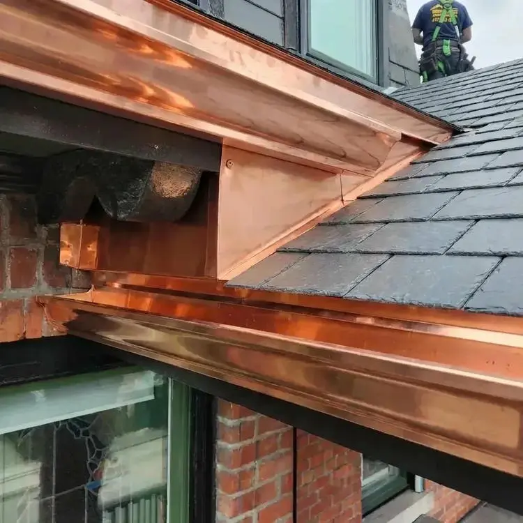 Custom fabricated copper soffit bulkhead wildlife enclosure and copper flat roof installation on a completed slate roof replacement in Toronto by Right Choice Roofing and Repair.