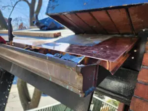 Custom copper flashing installation on a soffit bulkhead to prevent squirrel infestation in Toronto by Right Choice Roofing and Repair.