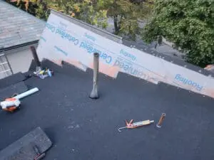 Modified bitumen base sheet installed on a Rosedale Toronto flat Roof with CertainTeed DiamondDeck underlayment on the Dormer sloped Roof and aluminum high dome flanges staged for installation