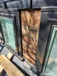 Right Choice Roofing and Repair removing failing slate tiles from a Toronto dormer to expose the wood board substrate for inspection.