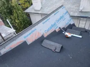 CertainTeed DiamondDeck synthetic underlayment installed up a Dormer sloped Roof on a Rosedale Toronto home with modified bitumen base sheet on the flat Roof below and stacked original Slate tiles