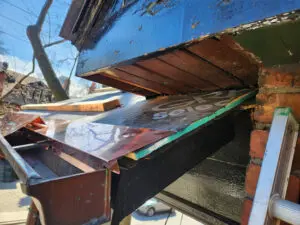Substrate preparation for a custom copper flashing enclosure to prevent squirrel infestation in Toronto by Right Choice Roofing and Repair.