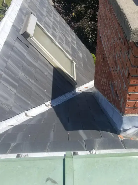 Before photo showing skylight with original lead flashing on slate roof next to brick chimney in Harbord Village Toronto prior to replacement by Right Choice Roofing and Repair