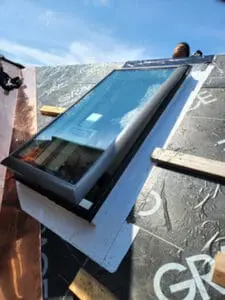 Progress photo showing new deck mount Velux skylight installed in Grace Select underlayment on main slope during slate roof replacement in Harbord Village Toronto by Right Choice Roofing and Repair