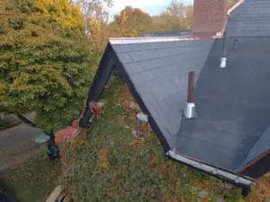 Aerial view of a completed natural Slate Roof and flat Roof replacement in Rosedale Toronto with new vent stacks and copper Eavestrough detail