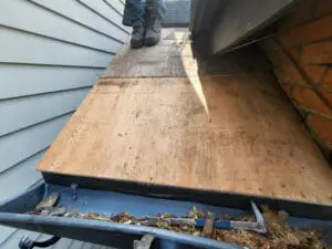 Progress photo showing new plywood roof deck sheathing installed on main sloped roof during carpentry repair stage of slate roof replacement in Harbord Village Toronto by Right Choice Roofing and Repair