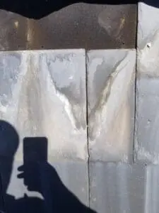 Progress photo showing aged and incorrectly spaced slate tiles allowing water infiltration behind tiles and down to fastening points on Harbord Village Toronto roof by Right Choice Roofing and Repair