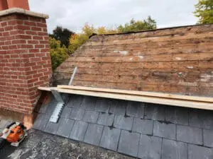 Slate Roof prep complete on a Rosedale Toronto heritage home with upper section stripped to the original board Sheathing, brick Chimney prepped, and work platform set up on the lower Slate by Right Choice Roofing and Repair