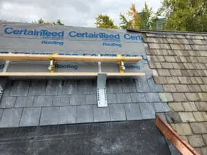 CertainTeed synthetic underlayment installed on a Rosedale Toronto heritage Slate Roof with a work platform set up and new copper Ridge Cap visible at the corner junction by Right Choice Roofing and Repair