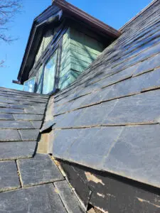 Deteriorating slate roof in Toronto showing damaged valley and dormer transition before replacement by Right Choice Roofing and Repair.