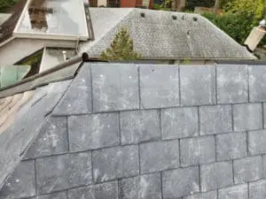 Completed natural Slate Roof Ridge closure on a Rosedale Toronto heritage home tying into the existing preserved original Slate Roof and aged copper Ridge Cap on the other side by Right Choice Roofing and Repair