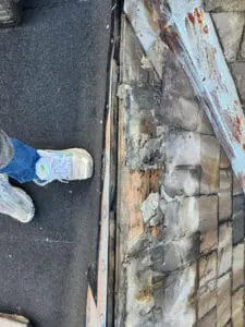 Galvanic corrosion and rust spots at old incorrect nail locations on the copper Ridge Cap of a Rosedale Toronto heritage Slate Roof, showing water penetration points before replacement