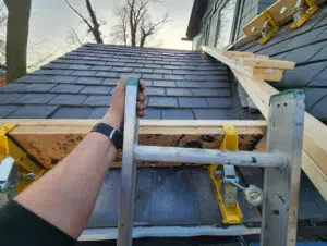 Engineered bridgework and specialized work platforms set up for a slate roof replacement job in Toronto.