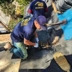 Right Choice Roofing and Repair team stripping back a 125-year-old slate roof in Toronto to inspect for wood rot and substrate integrity.