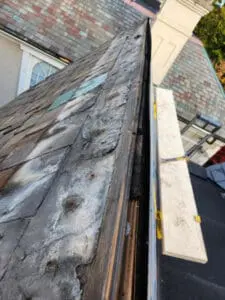Galvanic corrosion and rust staining running down the original Slate tiles from wrong nails used on the old copper Ridge Cap on a Rosedale Toronto heritage Roof